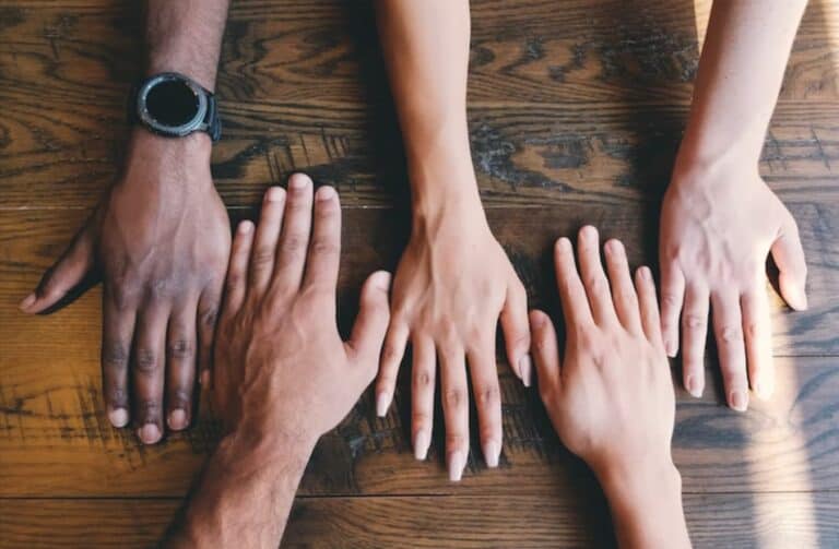 hands placed on a wooden table